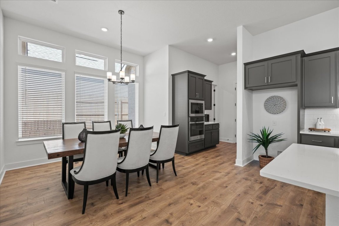 231 Begonia Street Buda, TX 78610 - Photo 20 of 27 a view of a dining room with furniture window and wooden floor