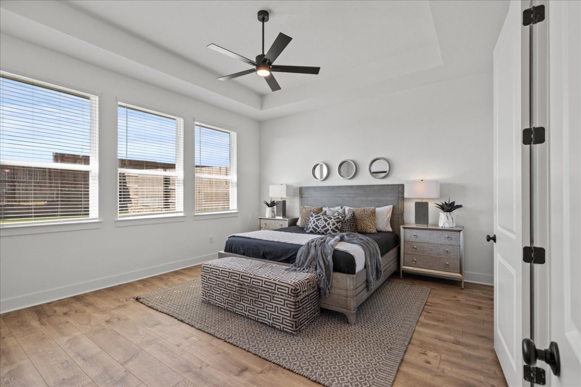 231 Begonia Street Buda, TX 78610 - Photo 22 of 27 a bedroom with a large bed and a window