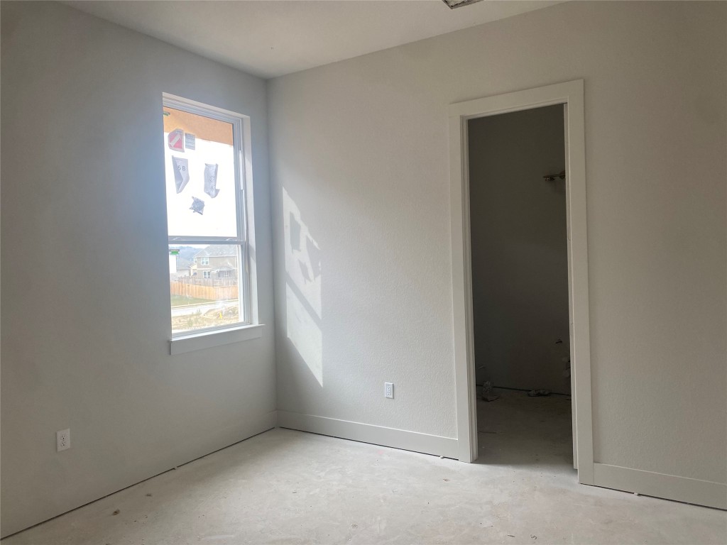 231 Begonia Street Buda, TX 78610 - Photo 6 of 27 an empty room with windows