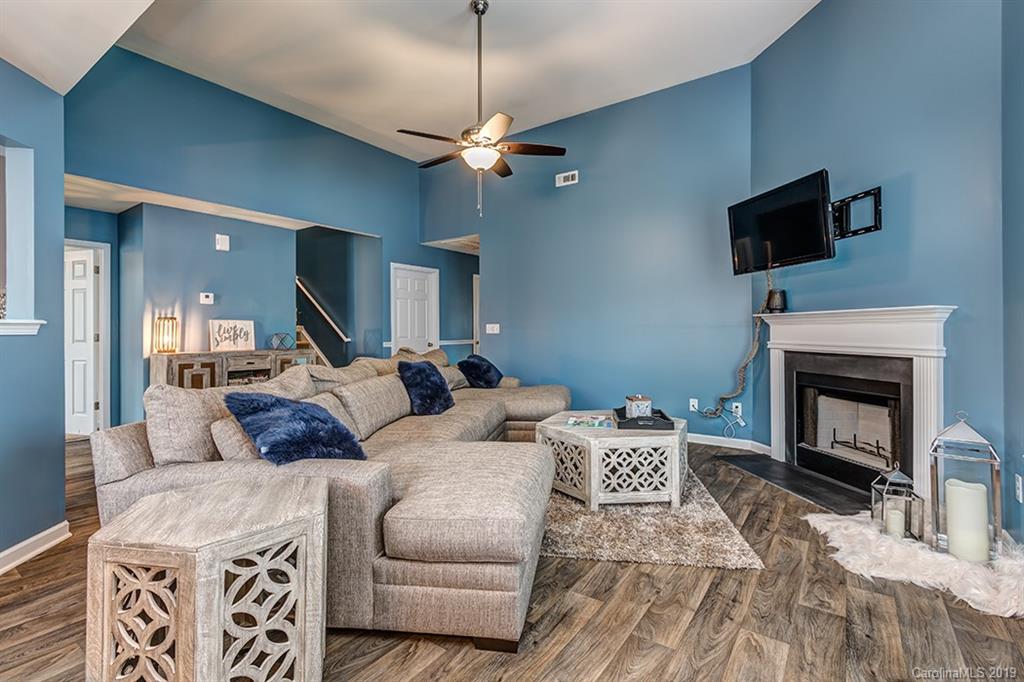 2736 Rustic Ridge Court Rock Hill, SC 29730 - Photo 11 of 23 a living room with furniture a flat screen tv and a fireplace