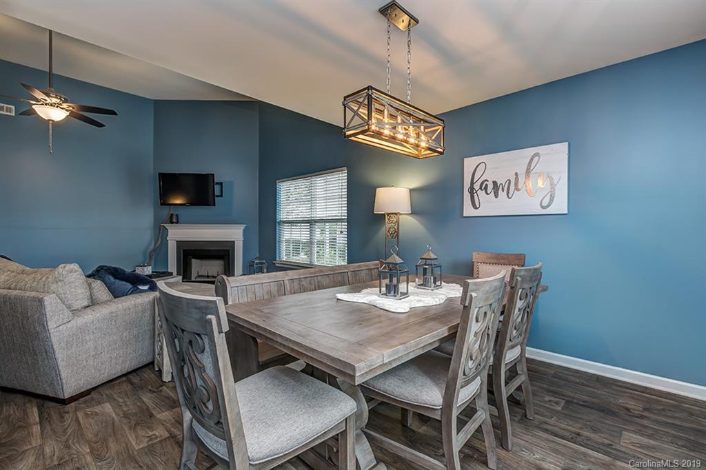 2736 Rustic Ridge Court Rock Hill, SC 29730 - Photo 14 of 23 a view of a dining room with furniture a chandelier and wooden floor