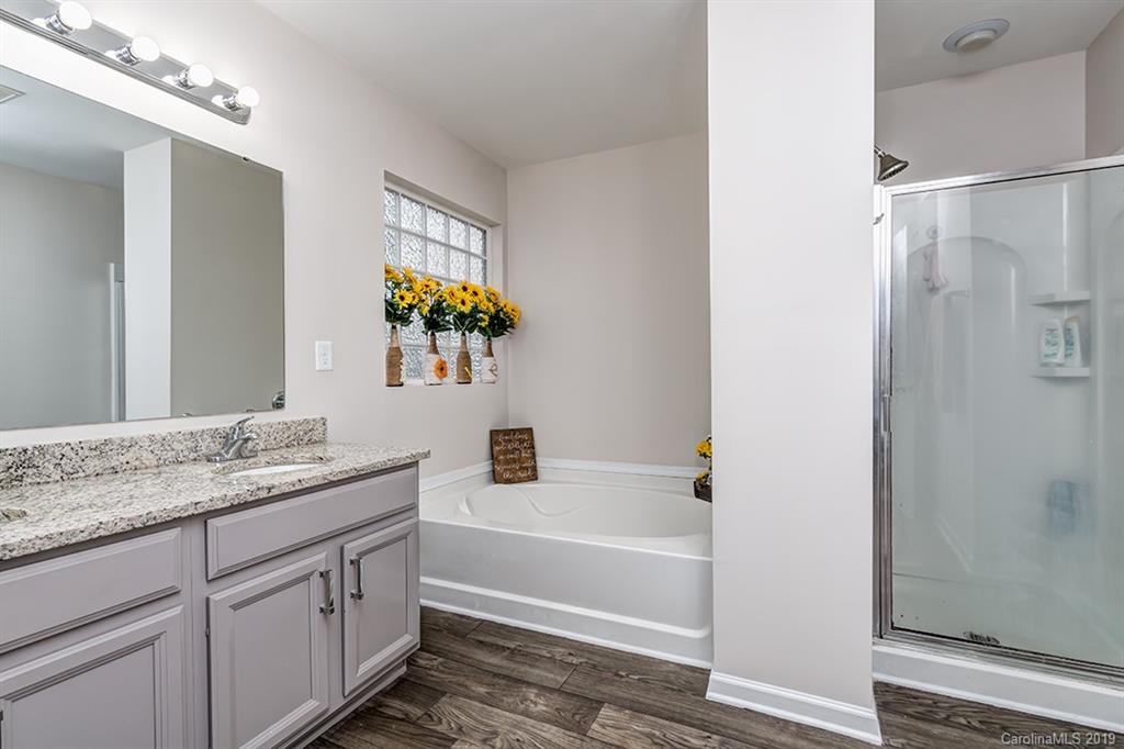 2736 Rustic Ridge Court Rock Hill, SC 29730 - Photo 3 of 23 a bathroom with a granite countertop tub sink and mirror
