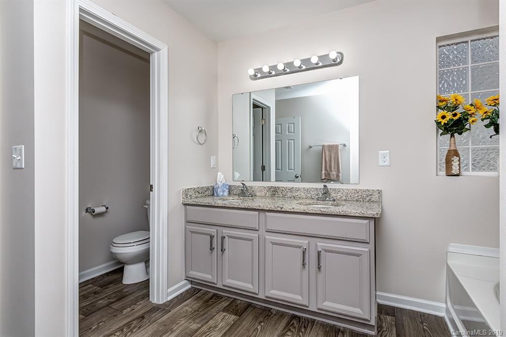 2736 Rustic Ridge Court Rock Hill, SC 29730 - Photo 4 of 23 a bathroom with a granite countertop sink a toilet and a mirror