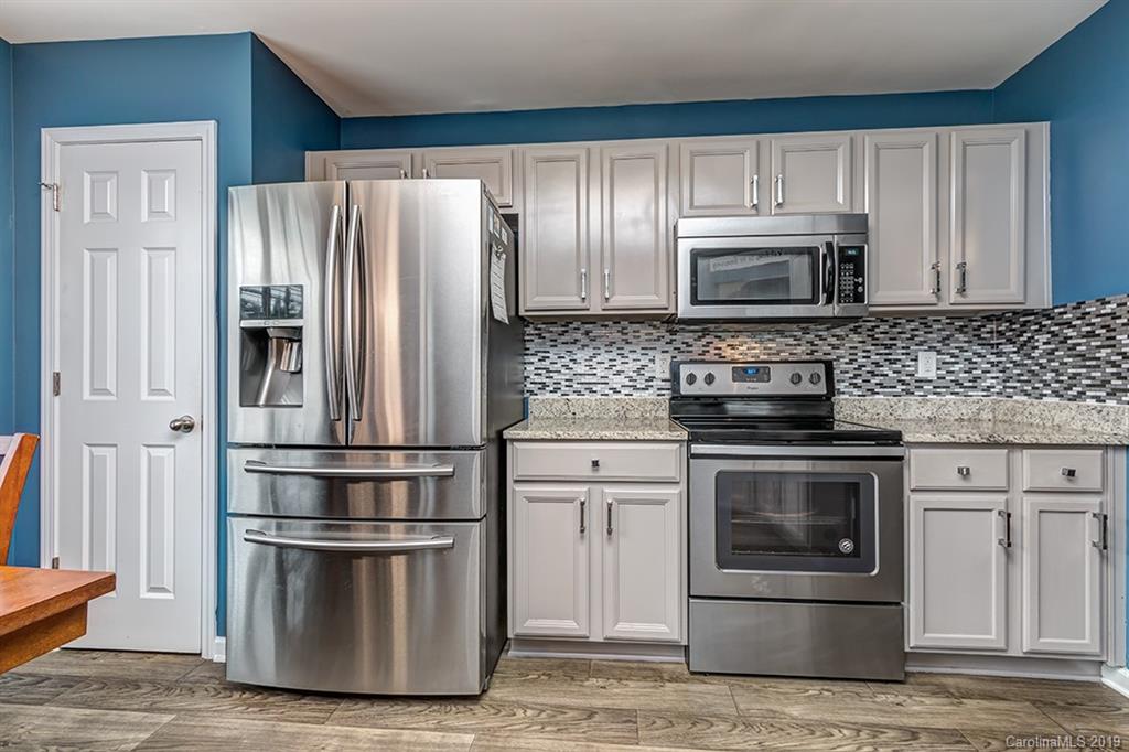 2736 Rustic Ridge Court Rock Hill, SC 29730 - Photo 6 of 23 a kitchen with stainless steel appliances granite countertop a refrigerator stove and microwave