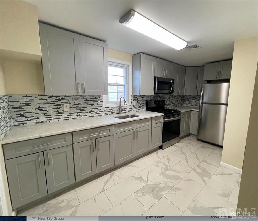 9 Christopher Street, Unit 2 Carteret, NJ 07008 - Photo 13 of 15 a kitchen with a sink stove and refrigerator