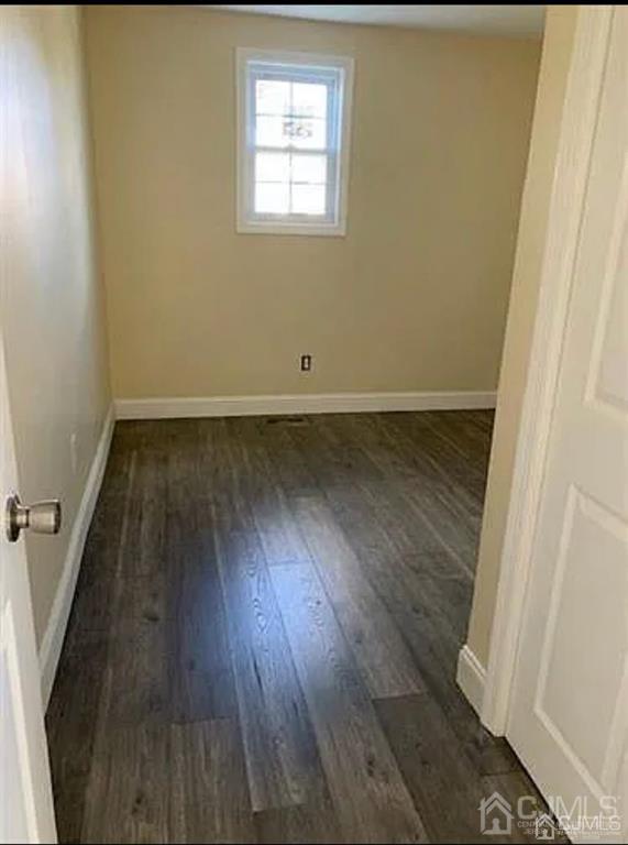 9 Christopher Street, Unit 2 Carteret, NJ 07008 - Photo 4 of 15 an empty room with wooden floor and windows