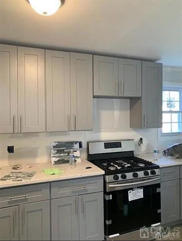 9 Christopher Street, Unit 2 Carteret, NJ 07008 - Photo 5 of 15 a kitchen with granite countertop a stove sink and cabinets