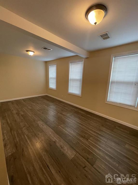 9 Christopher Street, Unit 2 Carteret, NJ 07008 - Photo 10 of 15 an empty room with wooden floor and windows