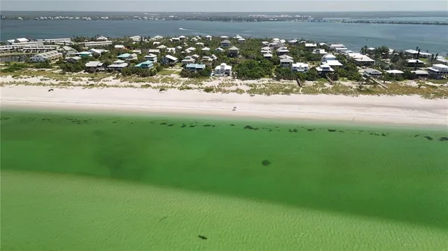 an aerial view of a house with a lake view