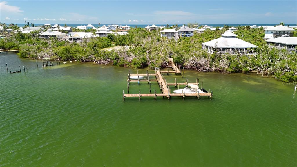 9502 Alborado Road Placida, FL 33946 - Photo 42 of 61 an aerial view of a house with a table chairs under an umbrella