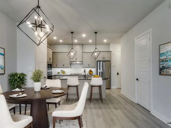 a kitchen with stainless steel appliances granite countertop a sink stove and cabinets