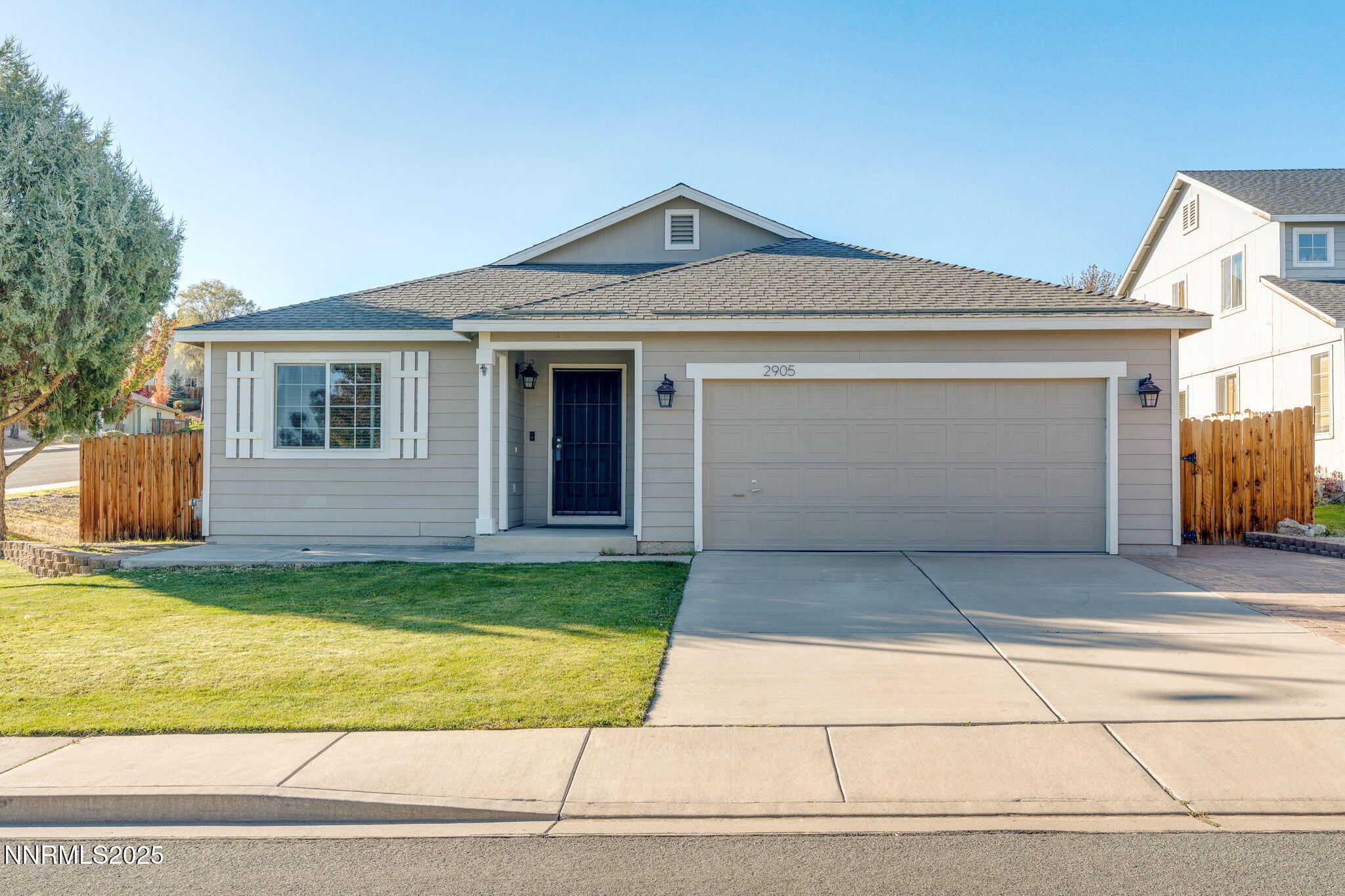 2905 Scepter Court Reno, NV 89503 - Photo 1 of 30 a front view of a house with a yard and garage
