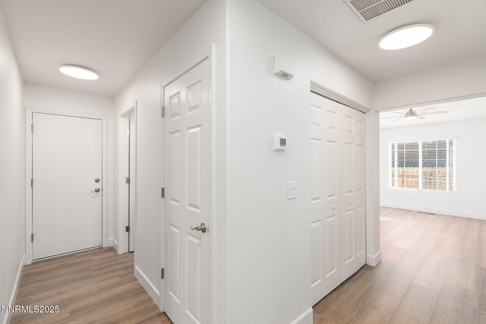 2905 Scepter Court Reno, NV 89503 - Photo 15 of 30 a view of a hallway with wooden floor and a bathroom