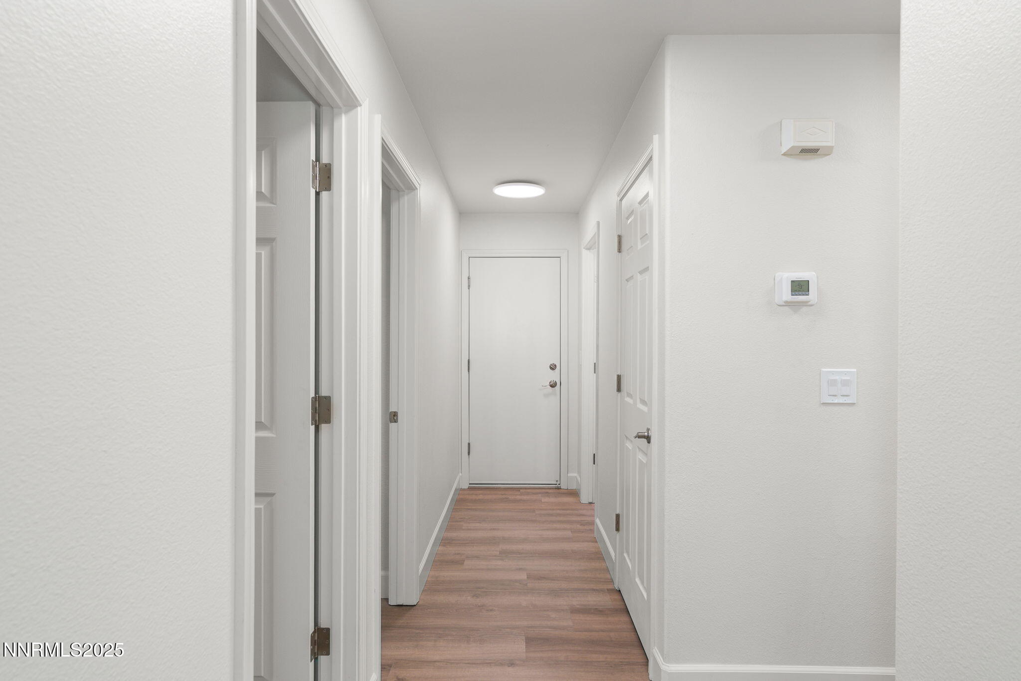 2905 Scepter Court Reno, NV 89503 - Photo 16 of 30 a view of a hallway with wooden floor and a bathroom