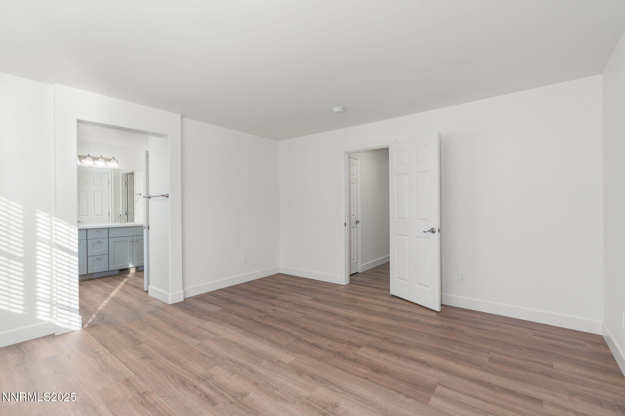 2905 Scepter Court Reno, NV 89503 - Photo 18 of 30 a view of an empty room with wooden floor and a window
