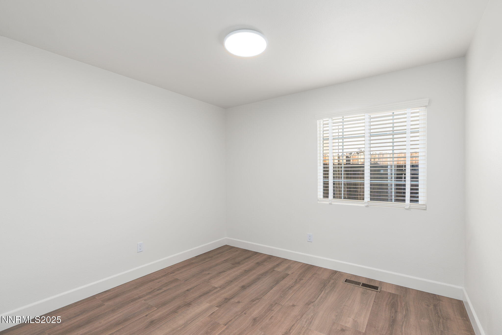 2905 Scepter Court Reno, NV 89503 - Photo 23 of 30 an empty room with wooden floor and windows