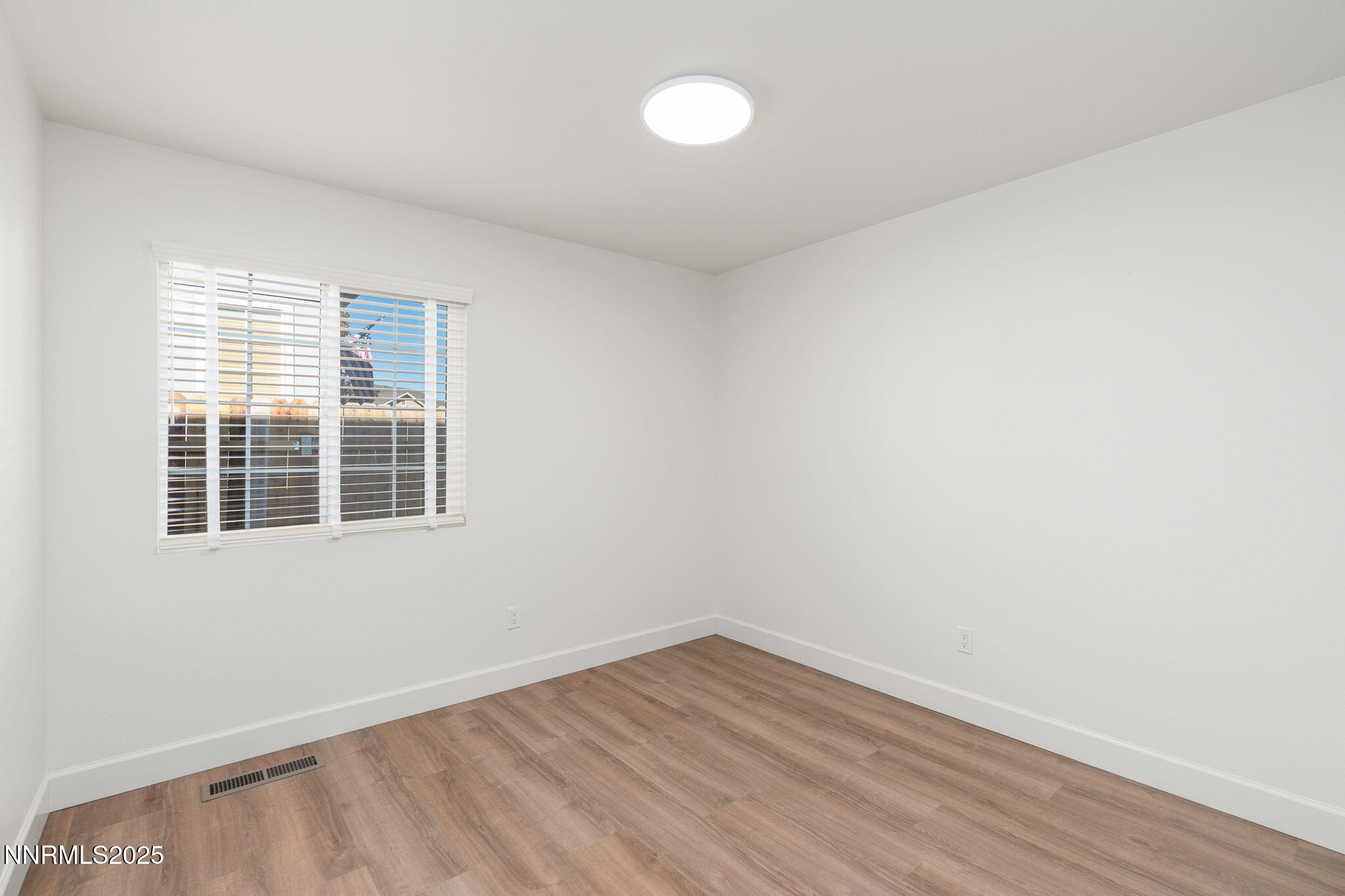 2905 Scepter Court Reno, NV 89503 - Photo 24 of 30 a view of an empty room with wooden floor and a window