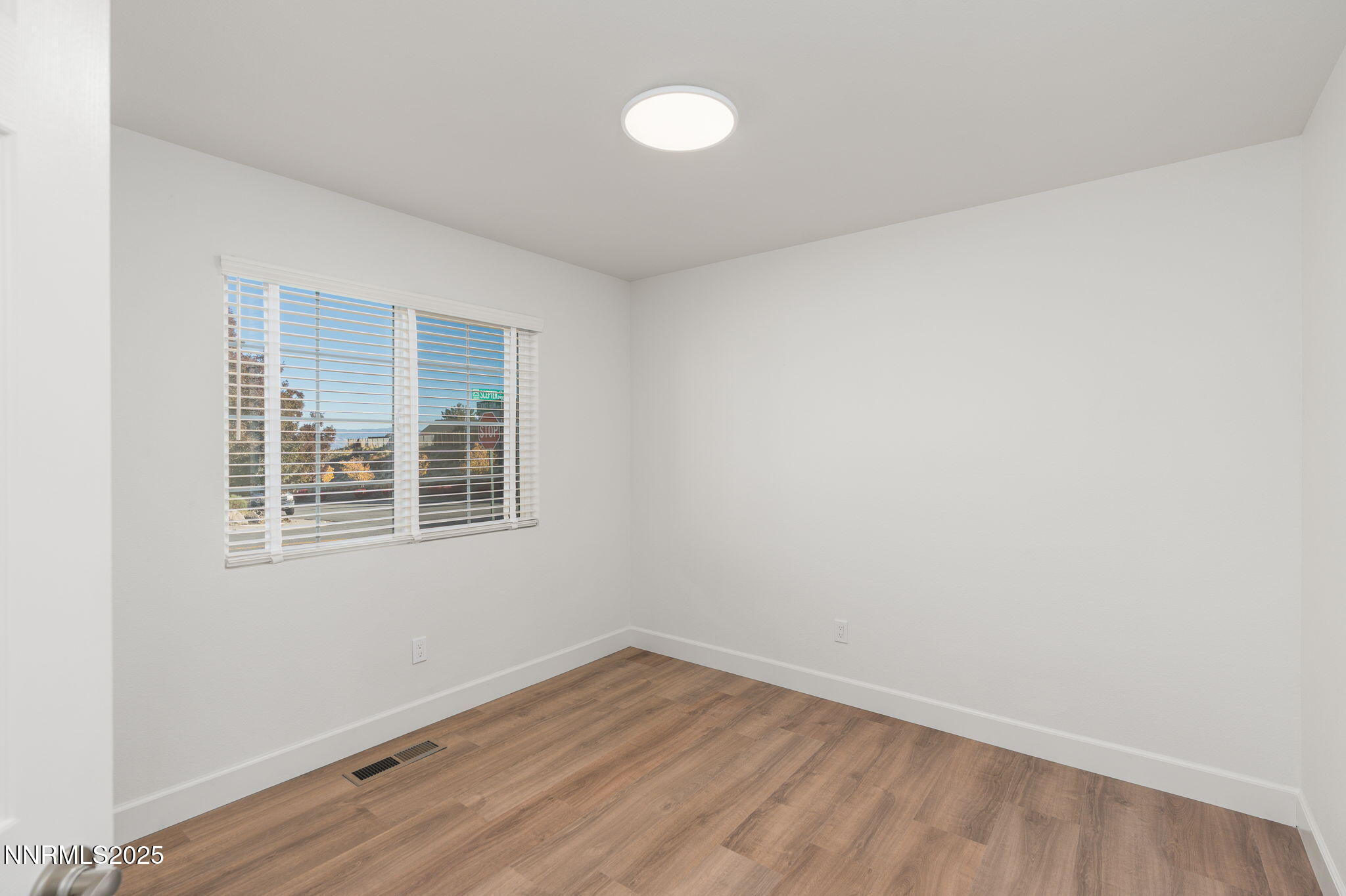 2905 Scepter Court Reno, NV 89503 - Photo 5 of 30 an empty room with wooden floor and windows
