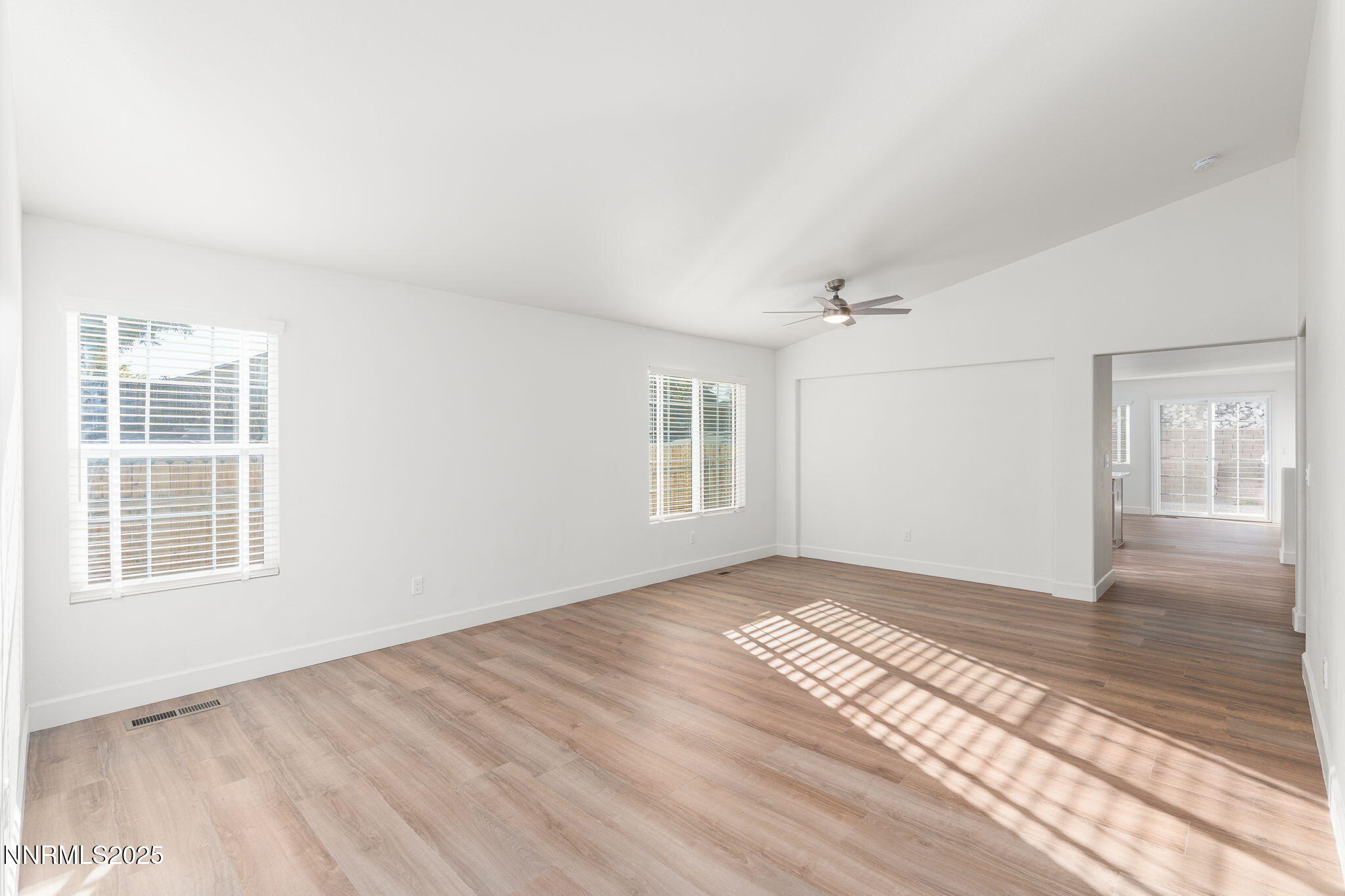 2905 Scepter Court Reno, NV 89503 - Photo 7 of 30 a view of an empty room with wooden floor and a window