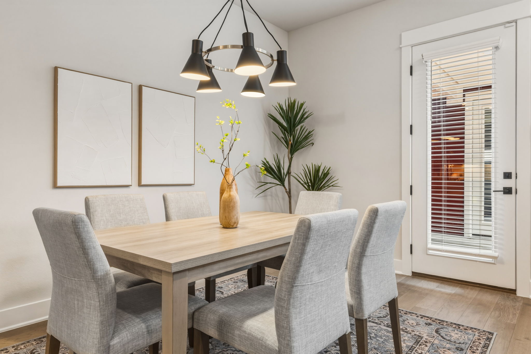 2929 Moreno Street Austin, TX 78723 - Photo 15 of 40 Dining area featuring wood-finish flooring and a white paneled door with integrated blinds