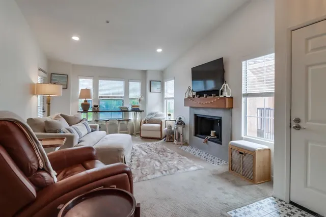 a living room with furniture a fireplace and a flat screen tv