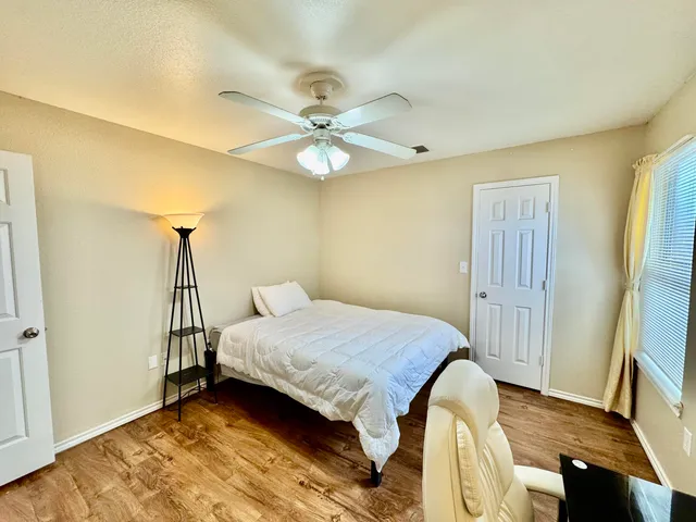 a bedroom with a bed dresser and a window