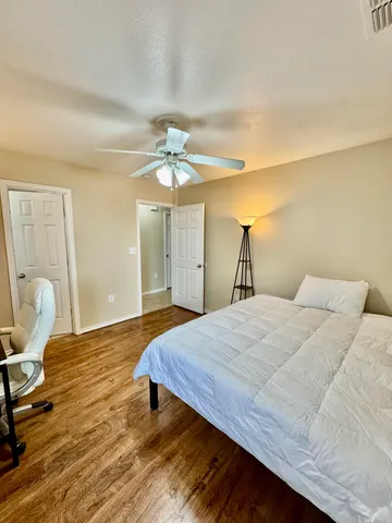a bedroom with a bed and a chandelier