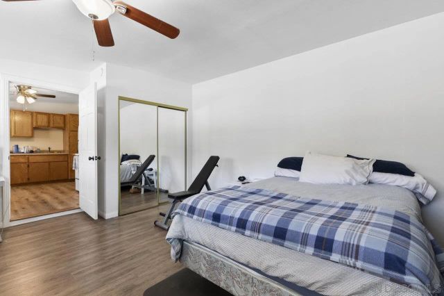 a kitchen with stainless steel appliances a sink a refrigerator and wooden floor