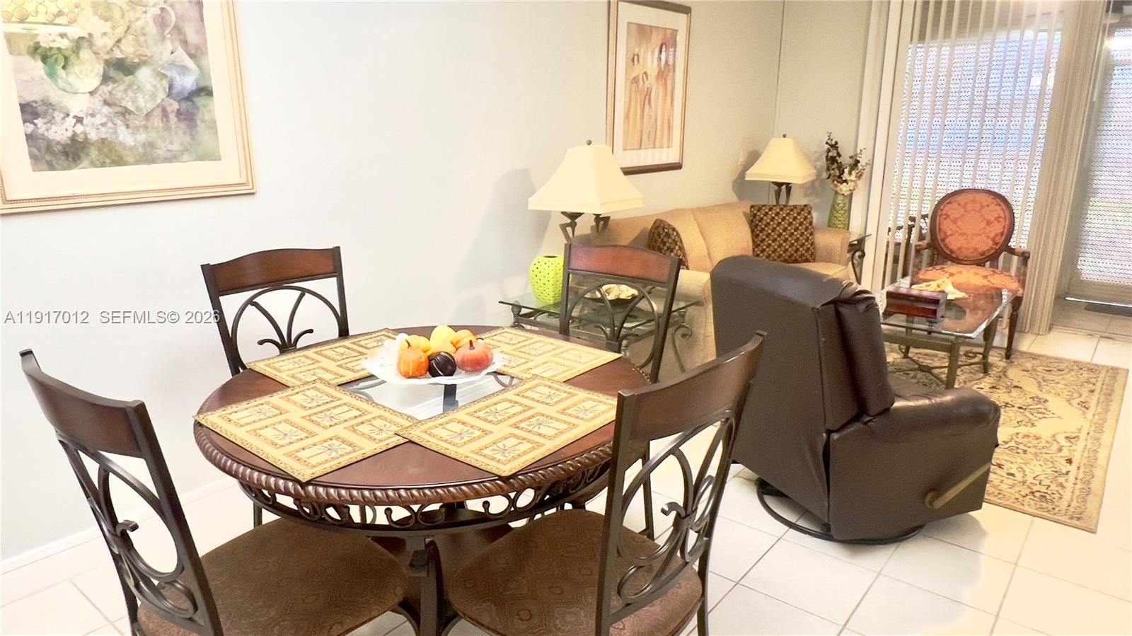 4380 27th Court Southwest, Unit 1104 Naples, FL 34116 - Photo 5 of 22 a view of a dining room with furniture and wooden floor