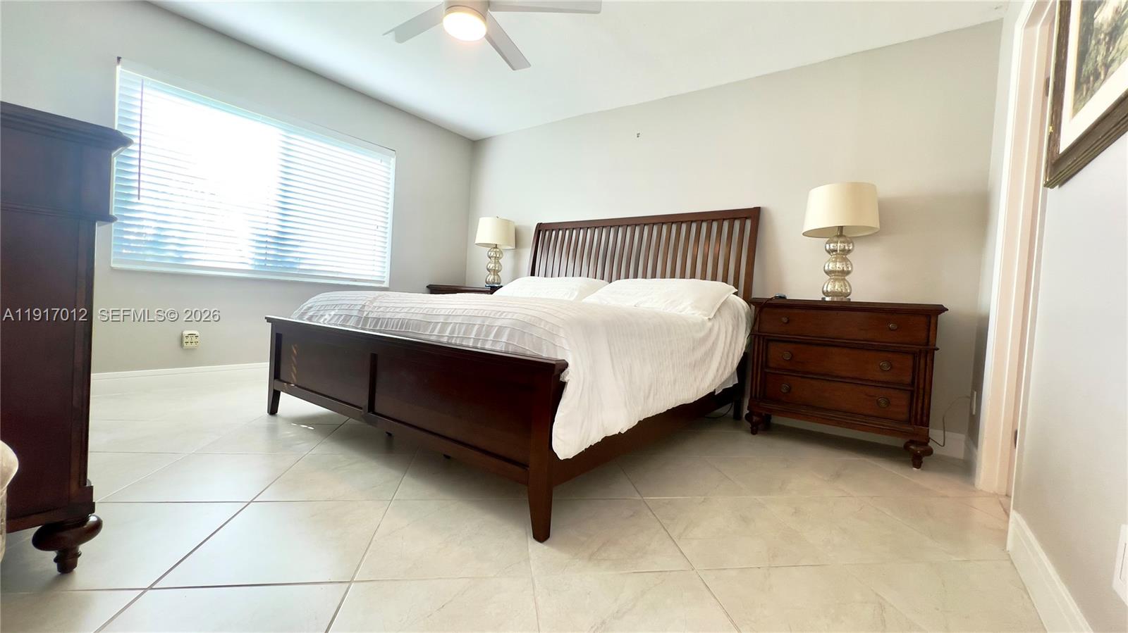 4380 27th Court Southwest, Unit 1104 Naples, FL 34116 - Photo 7 of 22 a bedroom with a bed and a dresser