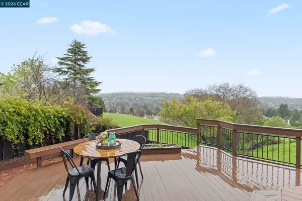 a view of a balcony with mountain view and wooden floor