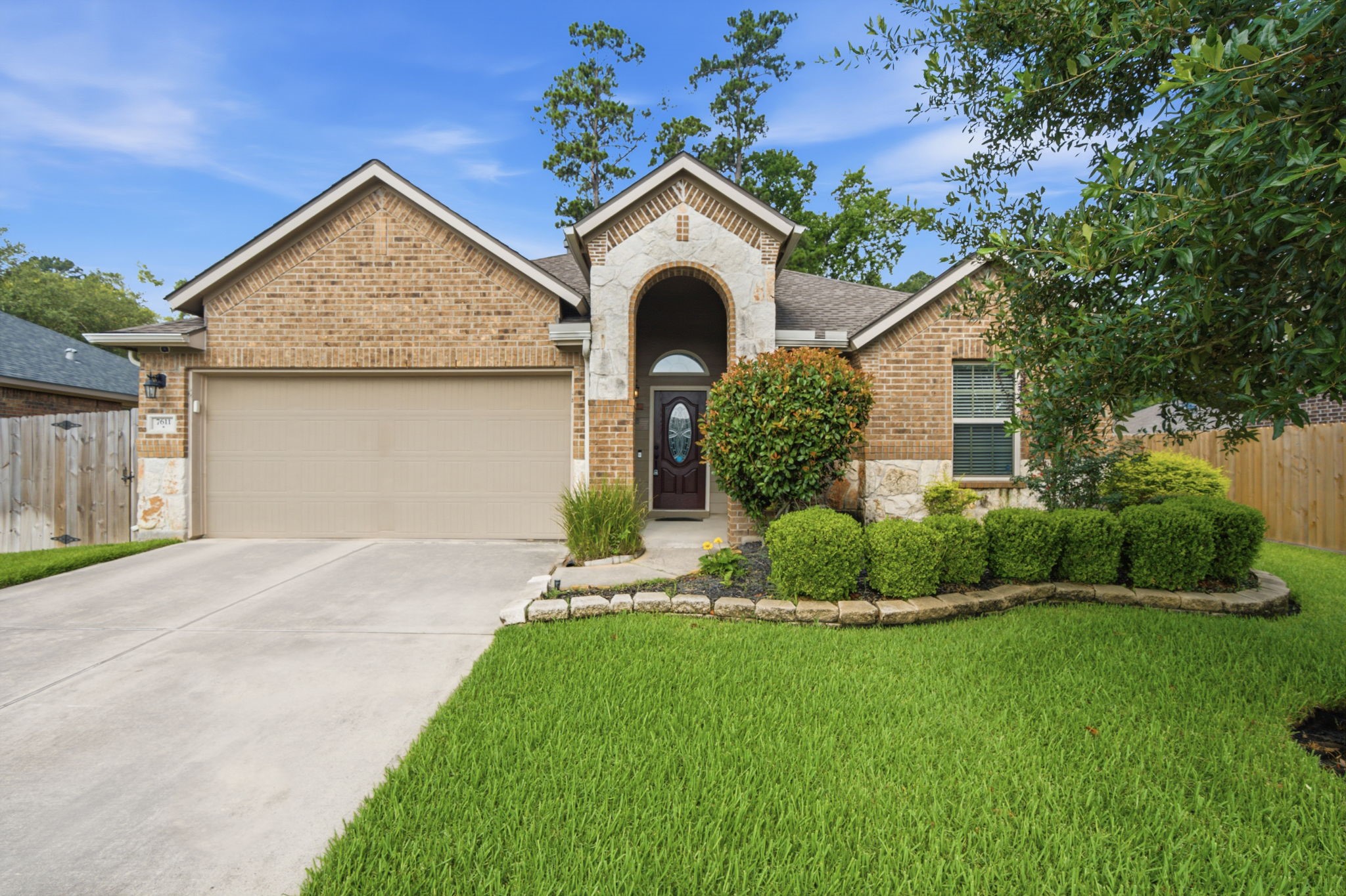 7611 Willow School Drive Spring, TX 77389 - Photo 2 of 23 a front view of a house with a yard and garage
