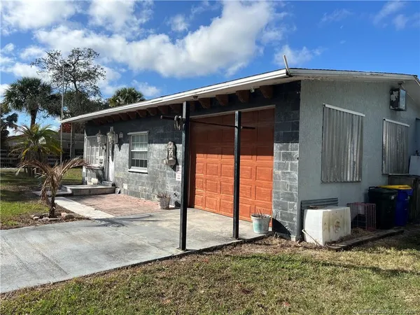 a backyard of a house with table and chairs
