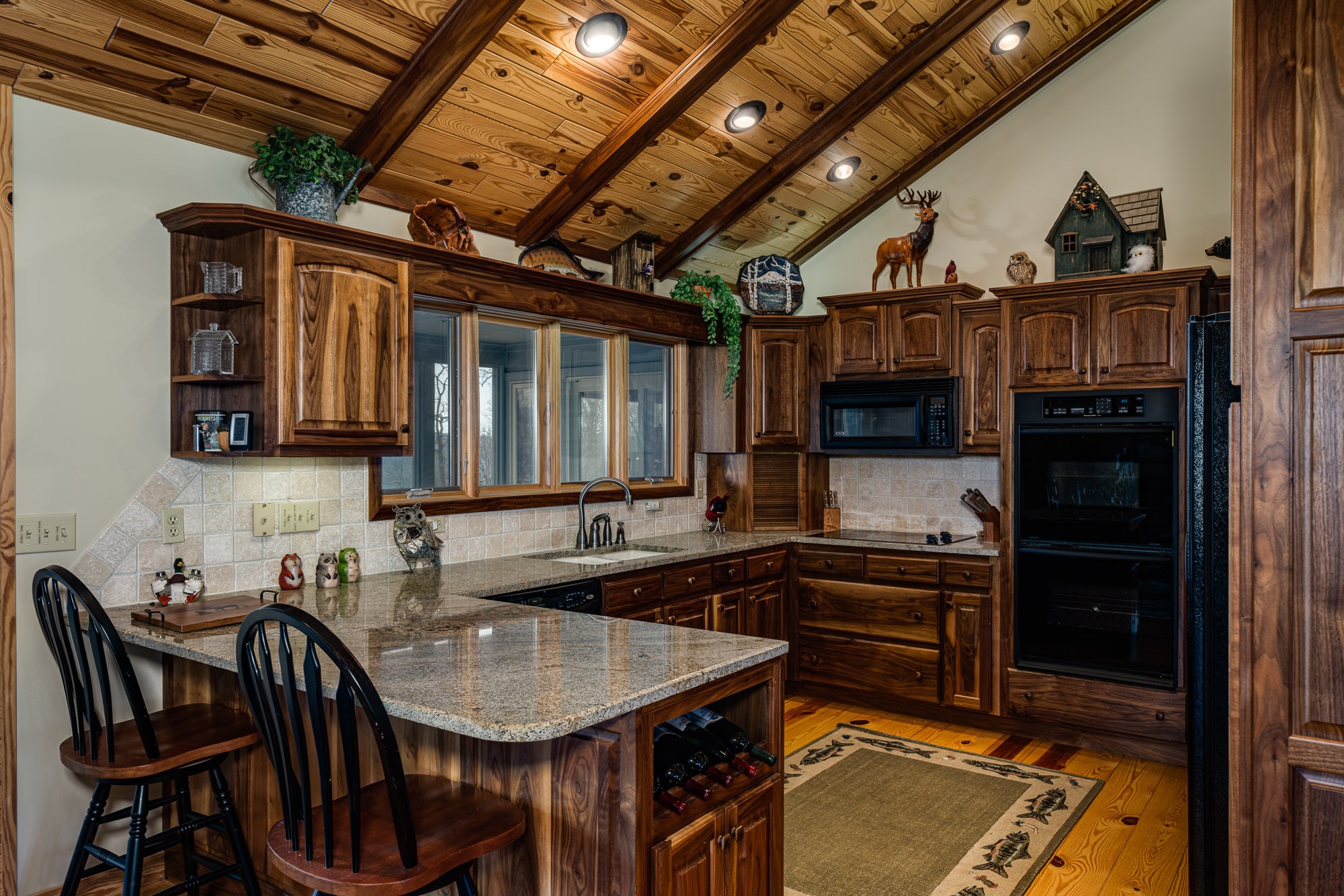 533 Mallard Pointe Road Byrdstown, TN 38549 - Photo 11 of 34 a kitchen with a sink a stove and chairs