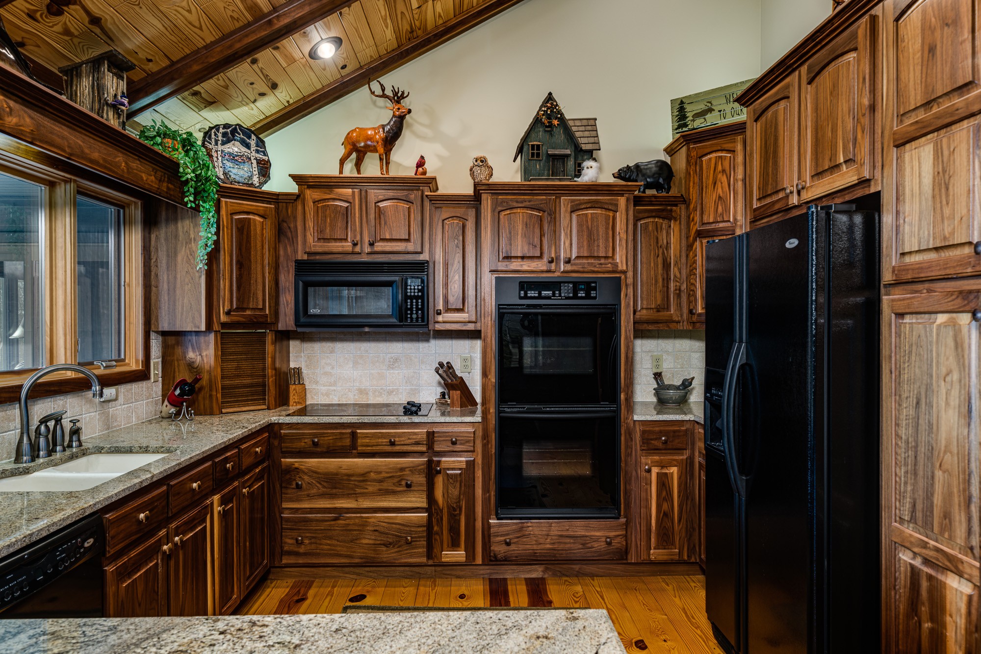 533 Mallard Pointe Road Byrdstown, TN 38549 - Photo 12 of 34 a kitchen with stainless steel appliances granite countertop a stove and a refrigerator
