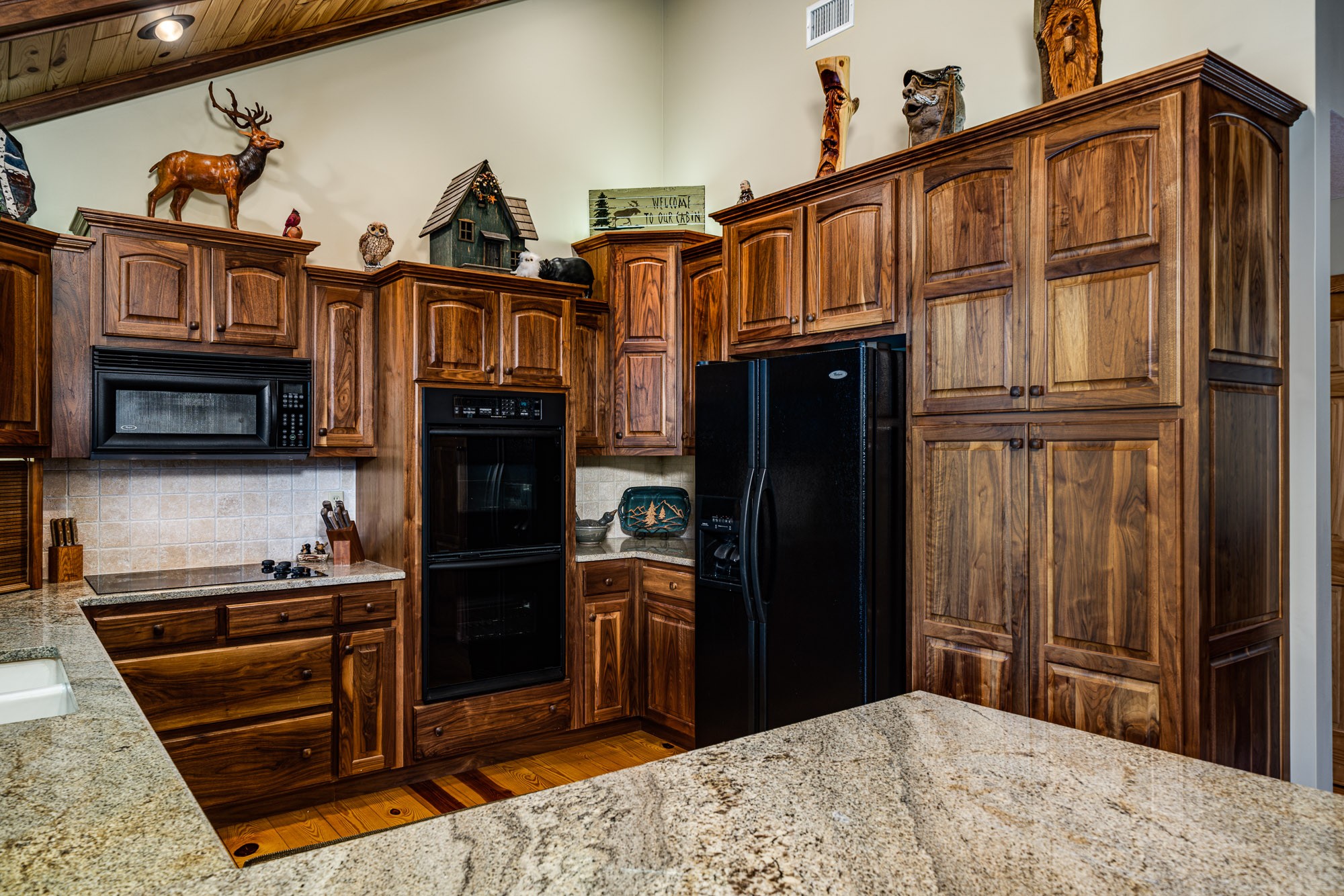 533 Mallard Pointe Road Byrdstown, TN 38549 - Photo 13 of 34 a kitchen with stainless steel appliances kitchen island granite countertop a refrigerator and a stove