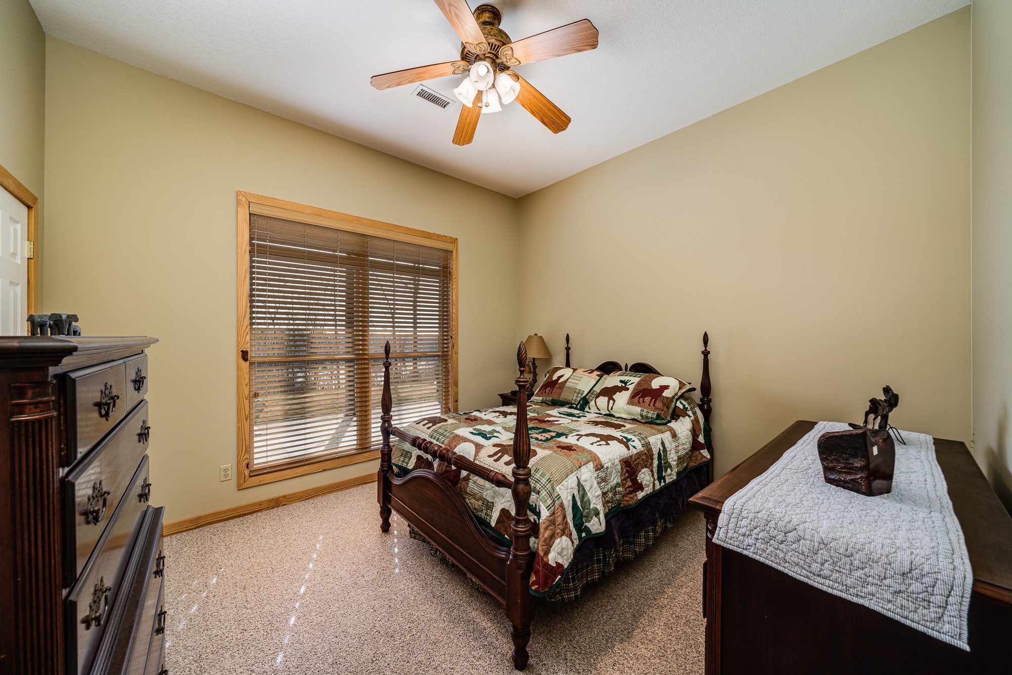 533 Mallard Pointe Road Byrdstown, TN 38549 - Photo 24 of 34 a bedroom with a bed and a chandelier