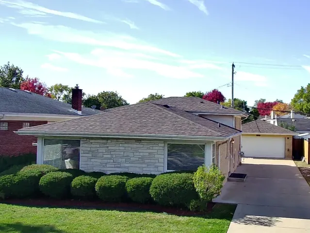 a aerial view of a house with a yard