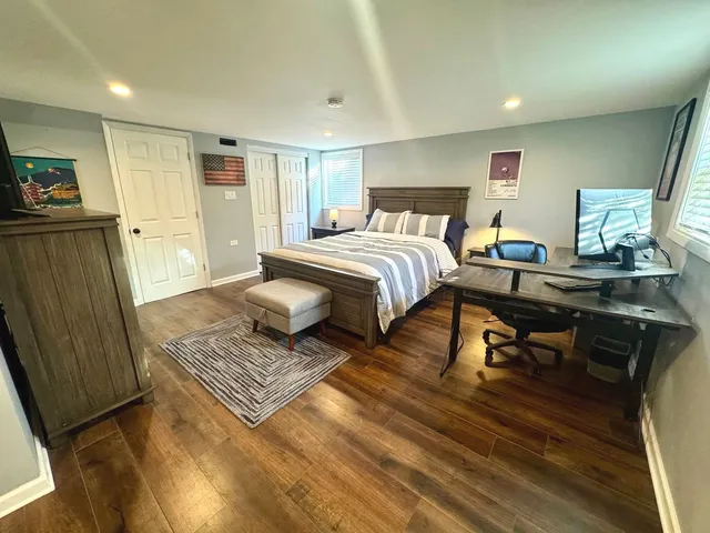 a bedroom with furniture and a rug