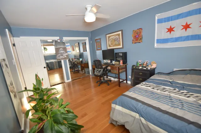 a bedroom with furniture and a wooden floor