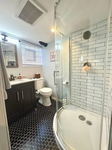 a bathroom with a sink toilet and shower