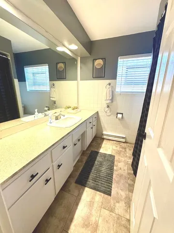 a spacious bathroom with a double vanity sink and a mirror
