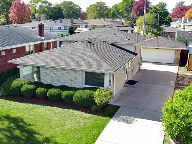 a aerial view of a house with a yard and plants