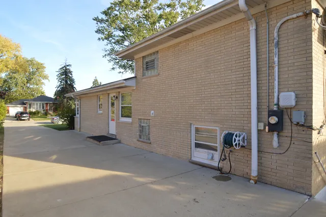 a view of a patio with a house and a yard