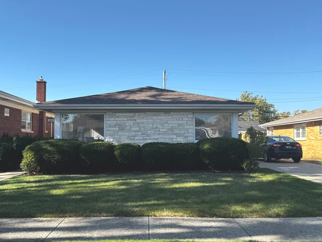 a front view of a house with a garden