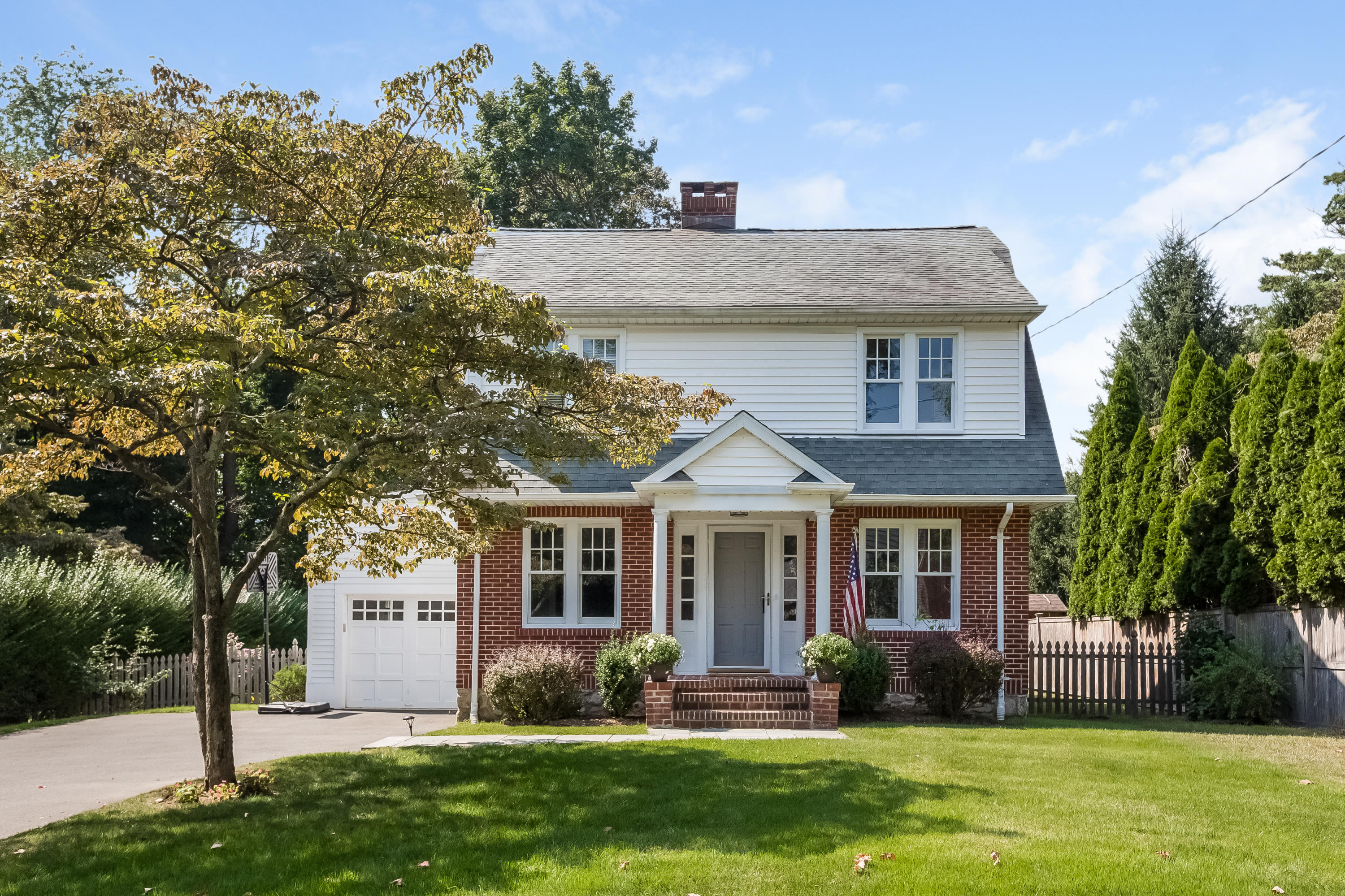 8 Garden City Road Darien, CT 06820 - Photo 1 of 30 a front view of a house with a yard and trees