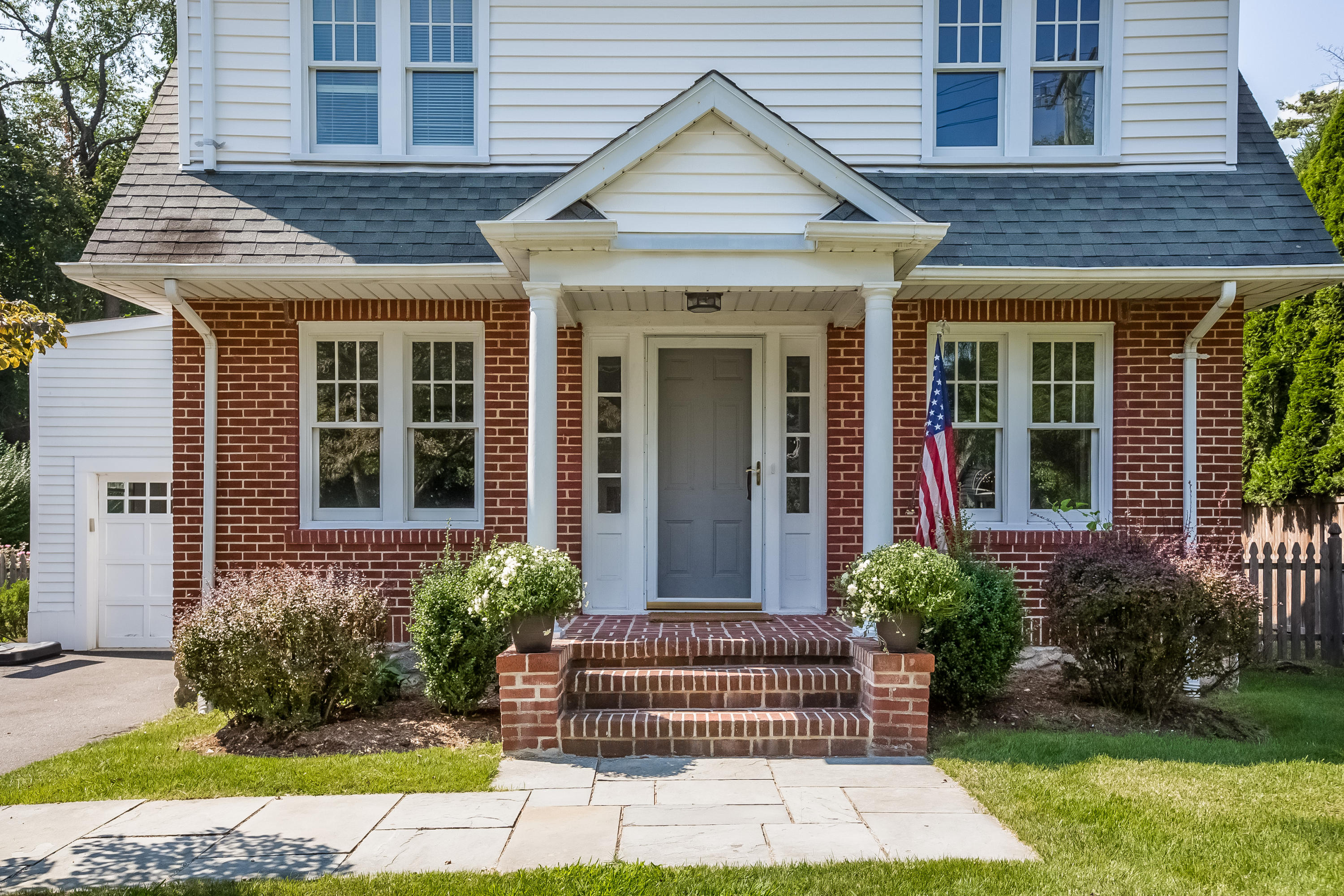 8 Garden City Road Darien, CT 06820 - Photo 2 of 30 a front view of a house with a garden