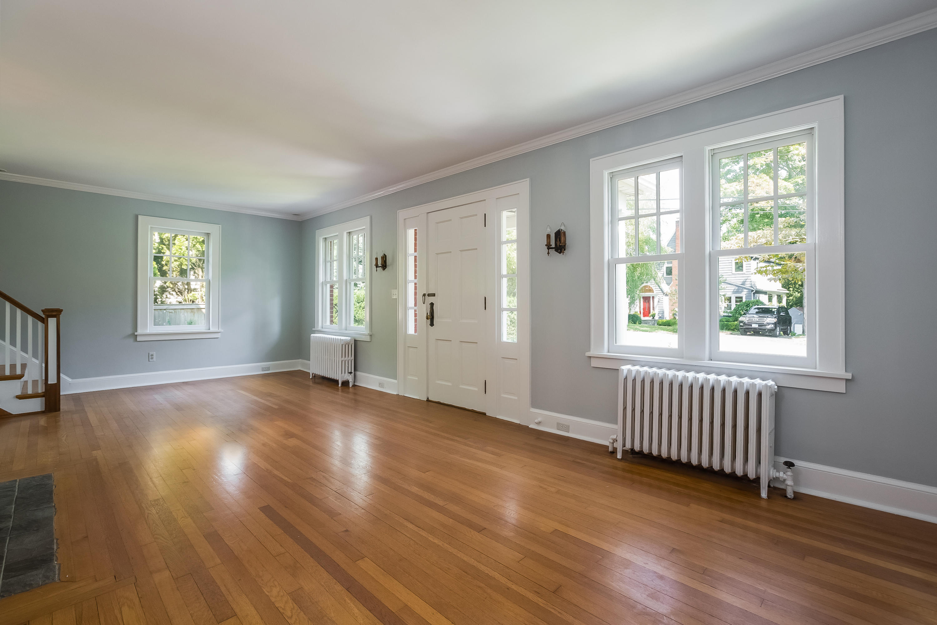 8 Garden City Road Darien, CT 06820 - Photo 3 of 30 an empty room with wooden floor and windows