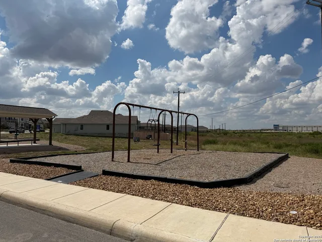 a view of a backyard with wooden fence
