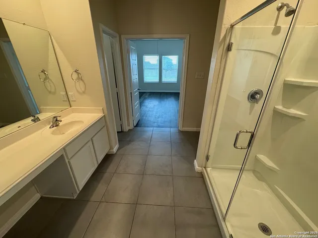 a bathroom with a tub sink and mirror